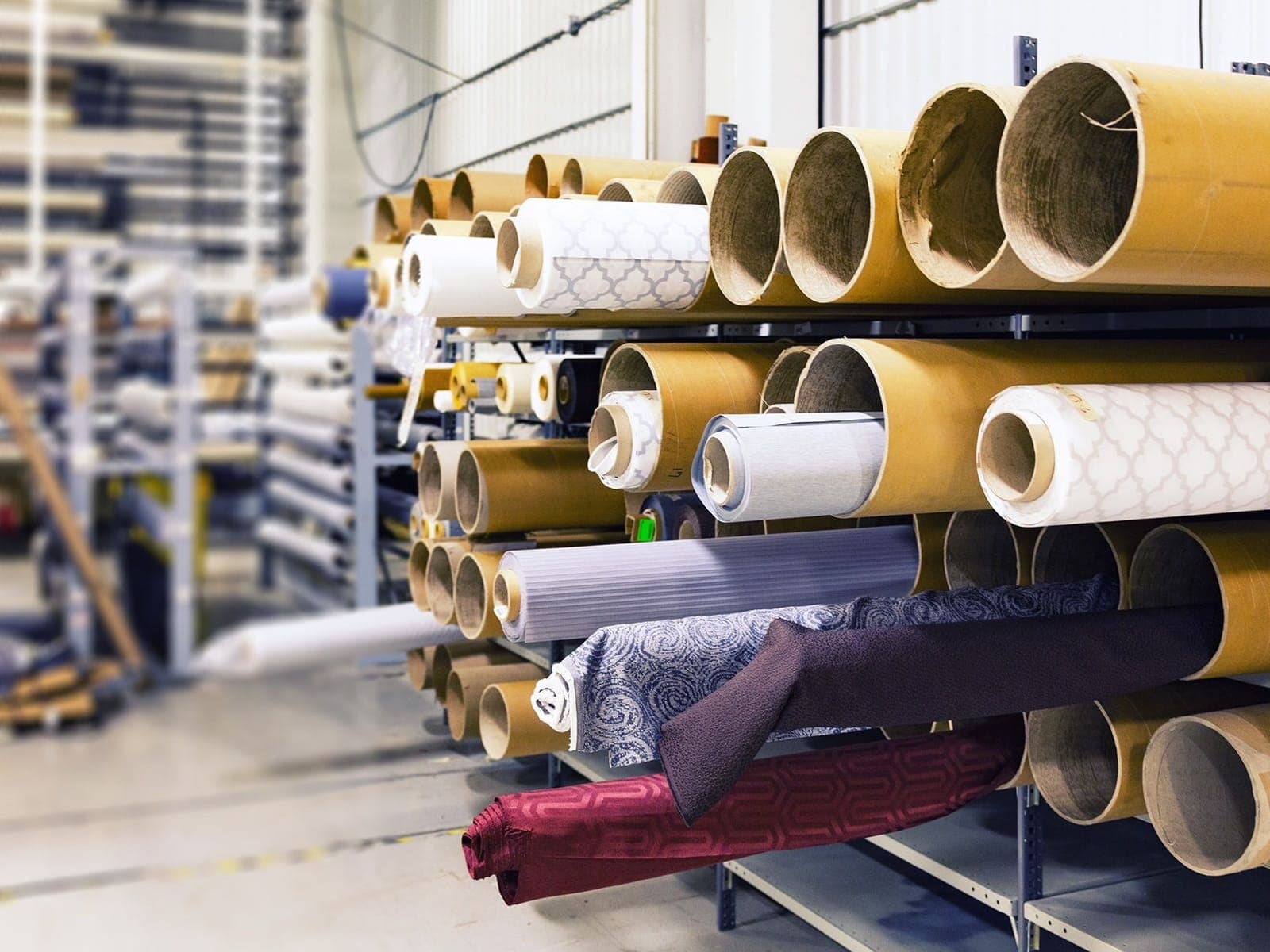 Rolls of fabric stored on a rack, ready for selection and costing